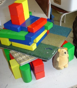 "First I made a square and I thought I could use blocks for the roof but it was too small for Snuffles so I made it so he can fit. It has 2 chimneys and a 2nd floor where he sleeps."