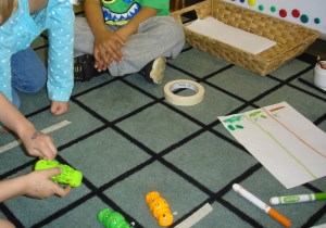 Racing caterpillars at the math centre. The children negotiated the length of the course and recorded the results of their races.