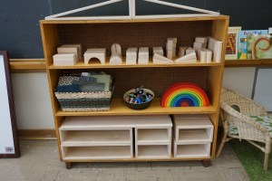 Blocks and building materials. The rainbow is from Grimm ("Rainbow Stacker") and provides endless opportunities for open ended play. The basket is full of carpet squares (different sizes) from Arts Junktion, there is also a basket of playskils (not visible).