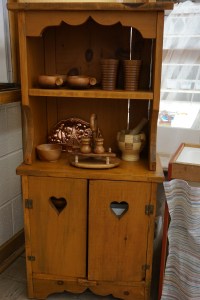 A closer look at the kitchen hutch filled with lovely wooden items from the thrift store.